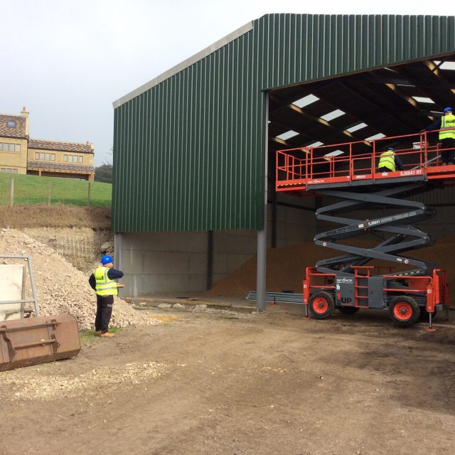 Engineers installing a new shutter for a warehouse